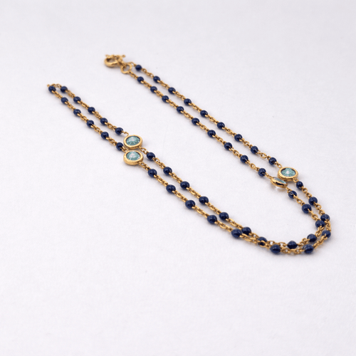 Collier Collier en or jaune 18 carats avec perles et topazes bleues 58 Facettes 34651