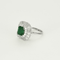 Bague jupe en or blanc centrée d'une émeraude de 2,05ct dans un double entourage de diamants