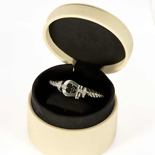 FRED - Montre de dame en acier à boitier en forme de manille et diamants