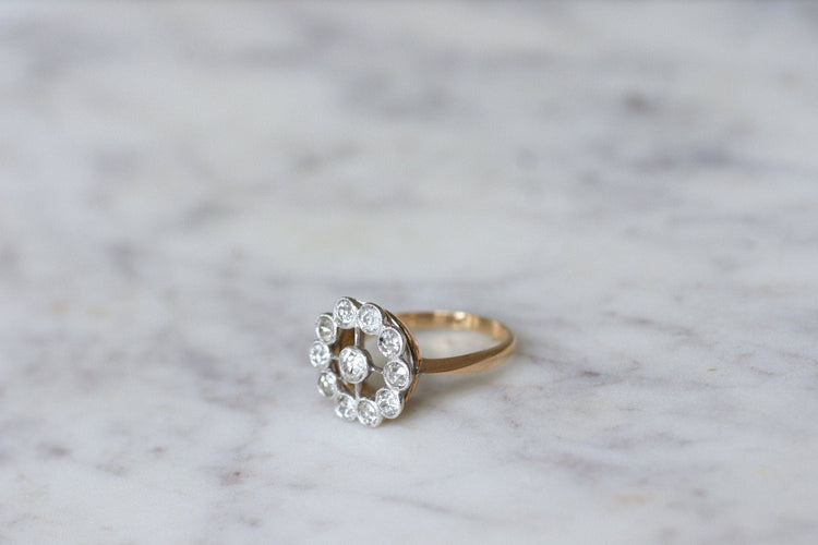 https://cdn.shopify.com/s/files/1/0075/4588/0666/products/bague-de-fiancailles-marguerite-ancienne-or-platine-et-diamants-845625.jpg?v=1645716760