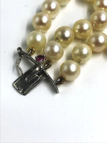 Bracelet Bracelet de perles à trois rangs du XXe siècle 58 Facettes