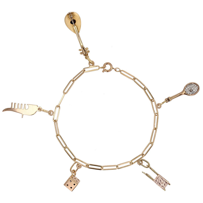 Bracelet gourmette or jaune et ses breloques