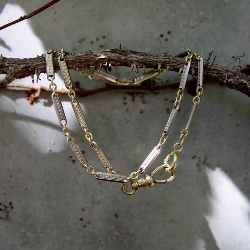 Montre Chaîne de montre Art Déco bicolore en or 10 carats avec fermoir mousqueton et anneau à ressort en or 14 carats 58 Facettes A20057