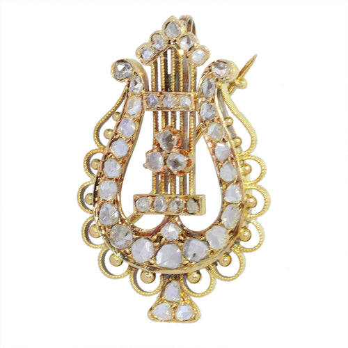 Diamants et harmonie : la broche-pendentif lyre en or des années 1870