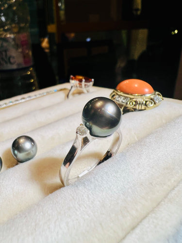 Bague en or sertie d'une perle de culture grise entourée de 2 diamants