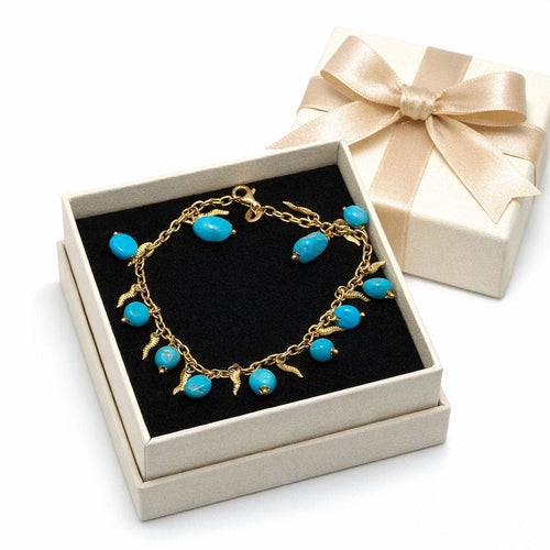 Bracelet Bracelet en or jaune avec perles turquoise et breloques décoratives 58 Facettes 50402