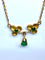 Collier pendentif trilobé en or jaune 18 carats et émeraudes