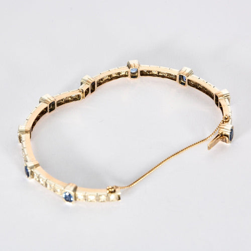 Bracelet Bracelet jonc ouvrant en or jaune et argent, diamants et saphirs 58 Facettes 230460