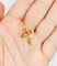 Pendentif Pendentif croix vintage or jaune finement travaillée ornée d'un rubis 58 Facettes A04922