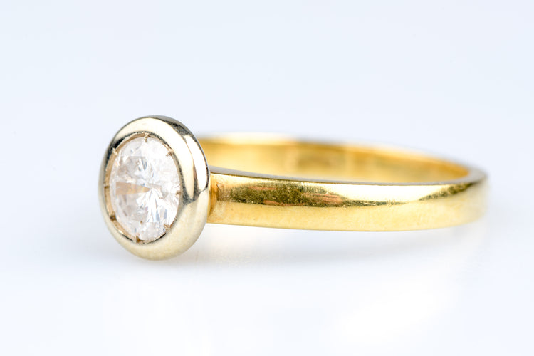 Bague solitaire en or jaune, serti clos d’un diamant rond brillant o,70 ct