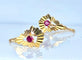 Boucles d’oreilles dormeuses en or jaune 18 carats et pierres rouges