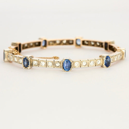 Bracelet Bracelet jonc ouvrant en or jaune et argent, diamants et saphirs 58 Facettes 230460