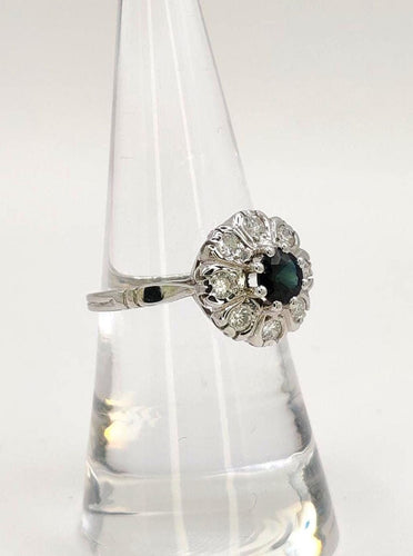 Bague 54 Bague Marguerite en or blanc ornée d'un saphir et de diamants 58 Facettes