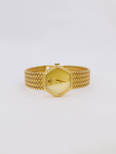 Montre BAUME & MERCIER Montre vintage or jaune maille tressée 58 Facettes 1067.3