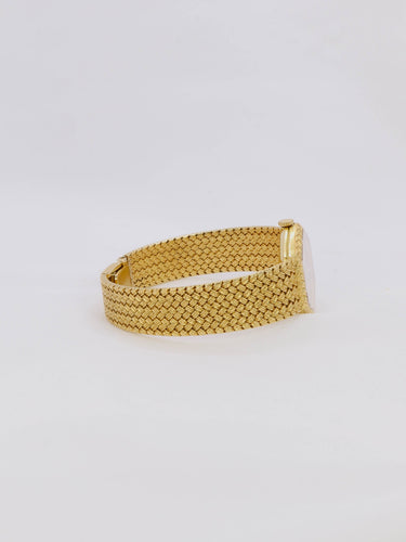 Montre BAUME & MERCIER Montre vintage or jaune maille tressée 58 Facettes 1067.3