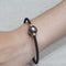 Bracelet Bracelet perle de Tahiti en acier noir et or jaune 58 Facettes PUV210