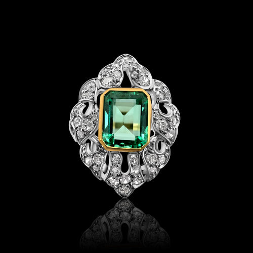 Bague Art Déco en or jaune et blanc sertie d'une émeraude.