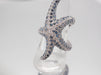 Ring 52 White gold starfish ring with sapphires and diamonds 58 Facettes