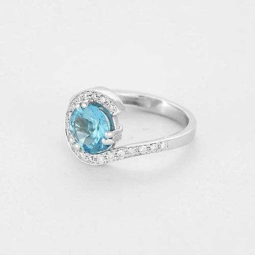 Bague 49 Bague tourbillon en or blanc, topaze et diamants 58 Facettes B250558