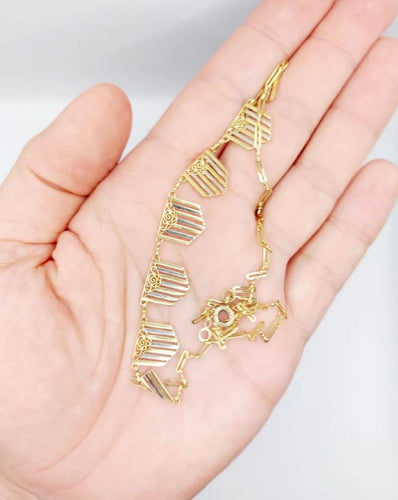 Collier Collier Art déco à motifs filigranés en or jaune et blanc 18k 58 Facettes A04100