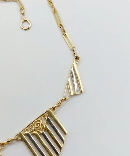 Collier Collier Art déco à motifs filigranés en or jaune et blanc 18k 58 Facettes A04100