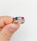 Bague 51 Bague jarretière Art déco en or blanc 18k, diamants, saphir et rubis 58 Facettes A03240
