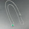 Collier Collier pendentif émeraude de Colombie entourée de diamants en or blanc 58 Facettes