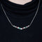 Collier Collier en or blanc 18 carats avec rubis, émeraudes et diamants 58 Facettes 1056180