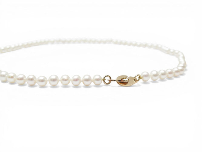 Collier Dinh Van - Collier menottes en or jaune 18k et perles d'eau douce 58 Facettes 273895