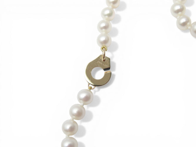 Collier Dinh Van - Collier menottes en or jaune 18k et perles d'eau douce 58 Facettes 273895