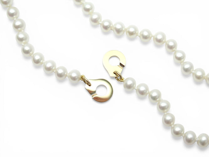 Collier Dinh Van - Collier menottes en or jaune 18k et perles d'eau douce 58 Facettes 273895