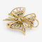 Broche Broche nœud en or jaune, diamants et émeraudes 58 Facettes 36314