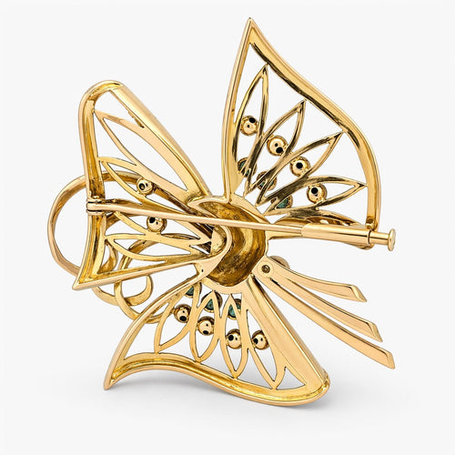 Broche Broche nœud en or jaune, diamants et émeraudes 58 Facettes 36314