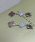 Boucles d'oreilles Van Cleef & Arpels Magic Alhambra - Boucles d’oreilles en or blanc, nacre et calcédoine 58 Facettes jnci115