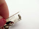 Broche Broche ruban torsadé en or blanc 18K et diamants 58 Facettes 275623