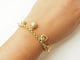 Bracelet Bracelet breloques en or jaune 18 carats et perles 58 Facettes 33799