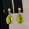 Boucles d'oreilles Green Radiance - Parure en or jaune 14 kt, péridots et diamants 58 Facettes S001