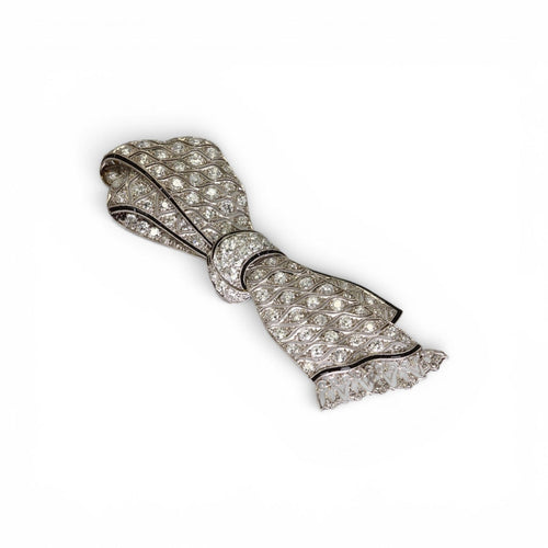 Broche nœud en platine, diamants et onyx 58 Facettes