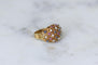 57 Bague boule cordage en or rose, saphirs, rubis et diamants 58 Facettes