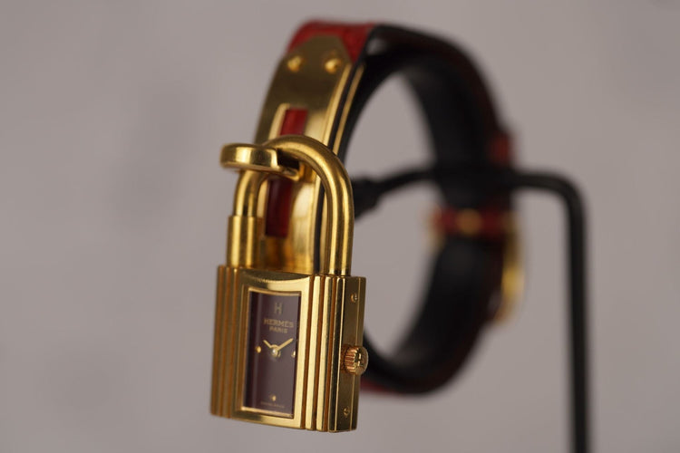 Hermès Kelly - Montre plaqué or sur cuir bordeaux 58 Facettes TOT-11128