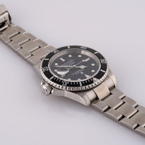 Rolex Submariner Date 16610T - Montre en acier 58 Facettes TOT-02011