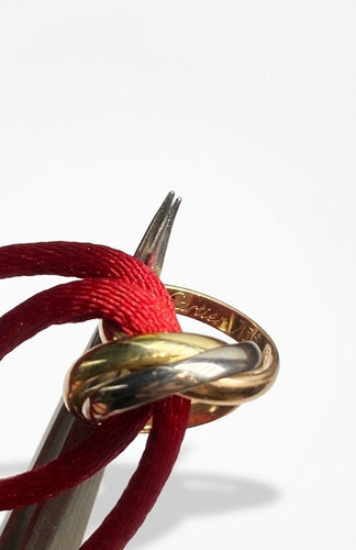 Cartier Trinity - Bracelet cordon en trois ors 18K 58 Facettes SKU : BOP/260063