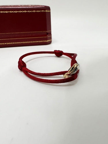 Cartier Trinity - Bracelet cordon en trois ors 18K 58 Facettes SKU : BOP/260063