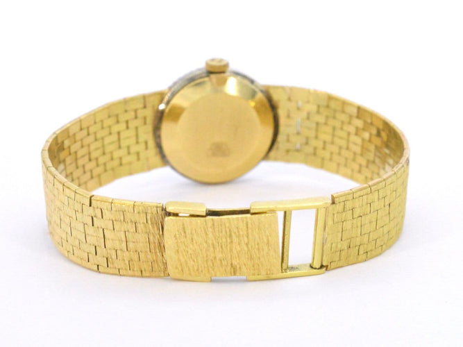 Omega - Montre mécanique en or 18 carats et diamants 58 Facettes 8034