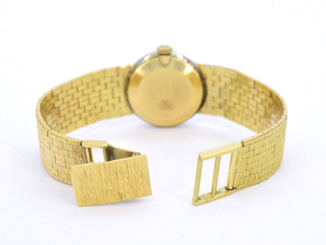 Omega - Montre mécanique en or 18 carats et diamants 58 Facettes 8034