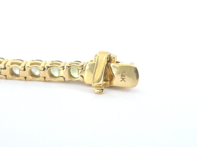 Bracelet tennis en or 14 carats et saphirs verts 58 Facettes 2905