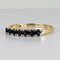 Bague 51 Bague demi-alliance en or jaune 14k avec sept saphirs 58 Facettes 2609003