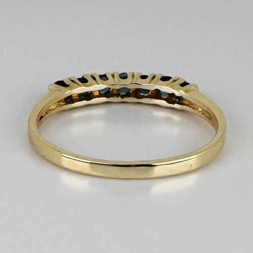 Bague 51 Bague demi-alliance en or jaune 14k avec sept saphirs 58 Facettes 2609003