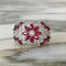 Bague 53 Bague dôme florale en or blanc 18k, rubis et diamants 58 Facettes 305