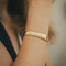 Bracelet Hermès - Bracelet jonc demi-ouvert en or jaune et blanc 18k avec diamants 58 Facettes 50239